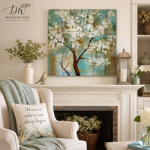 Load image into Gallery viewer, A square canvas wall art print depicting a blooming white cherry blossom tree against a turquoise and teal background, displayed in a styled living room above a white fireplace mantel.
