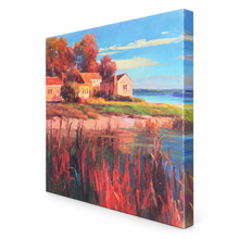 Charger l'image dans la galerie, A square gallery-wrapped canvas print featuring an impressionistic landscape painting with houses, trees, water, and reeds in warm reds, oranges, blues, and greens, shown at an angle on a white background.
