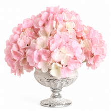 Load image into Gallery viewer, A large arrangement of pink and white hydrangea-style flowers in a distressed silver pedestal bowl, photographed on a clean white background.

