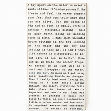 Load image into Gallery viewer, A vertical rectangular card with a cream background and black printed text, photographed against a dark background. The text appears to be a reflective journal entry or poem about boating and the ocean.
