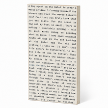 Load image into Gallery viewer, A rectangular wooden sign with a white background and black printed text, photographed at a slight angle against a white background.
