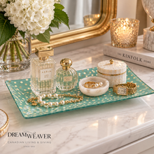 Load image into Gallery viewer, A styled interior scene on a white marble surface with a teal rectangular tray holding a glass perfume bottle, a pearl strand, a small white marble dish with gold jewelry, a white lidded box with gold trim, and a gold watch. A mirror, flowers, candles, and books are visible in the background.

